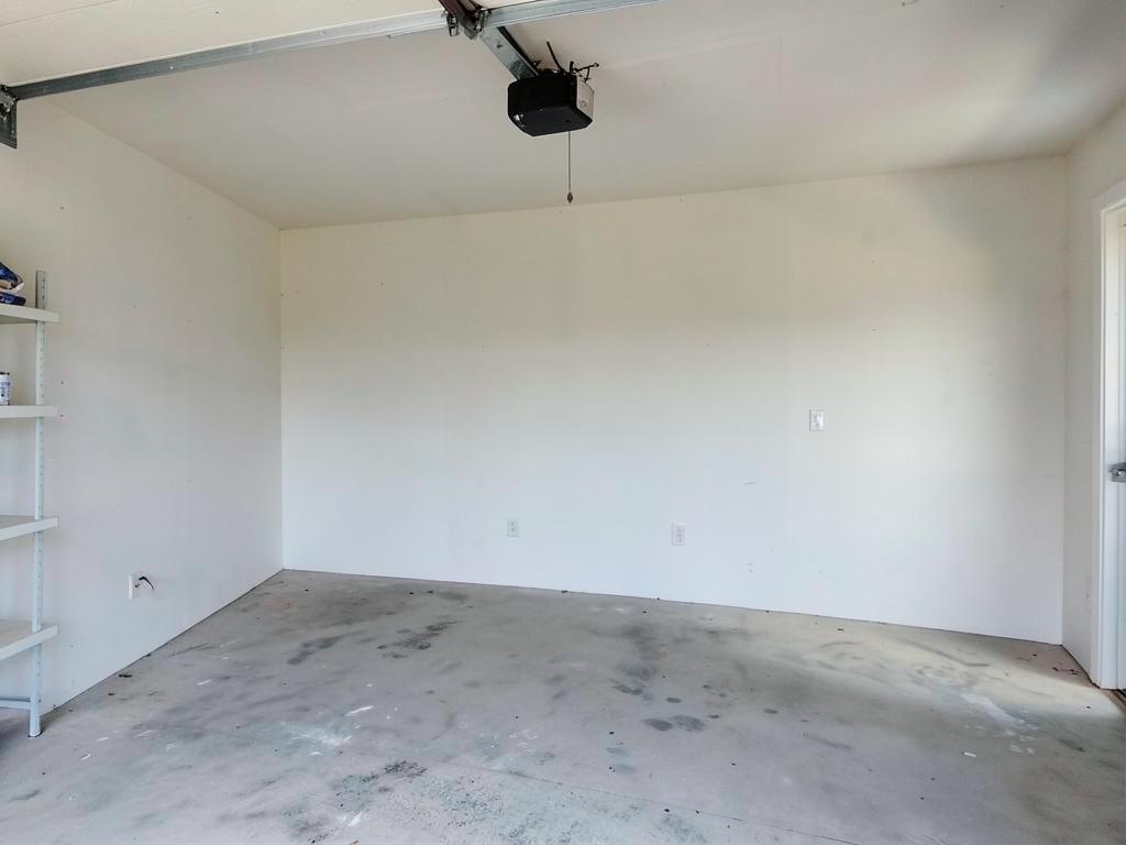 Empty far wall of a two-car garage before installation